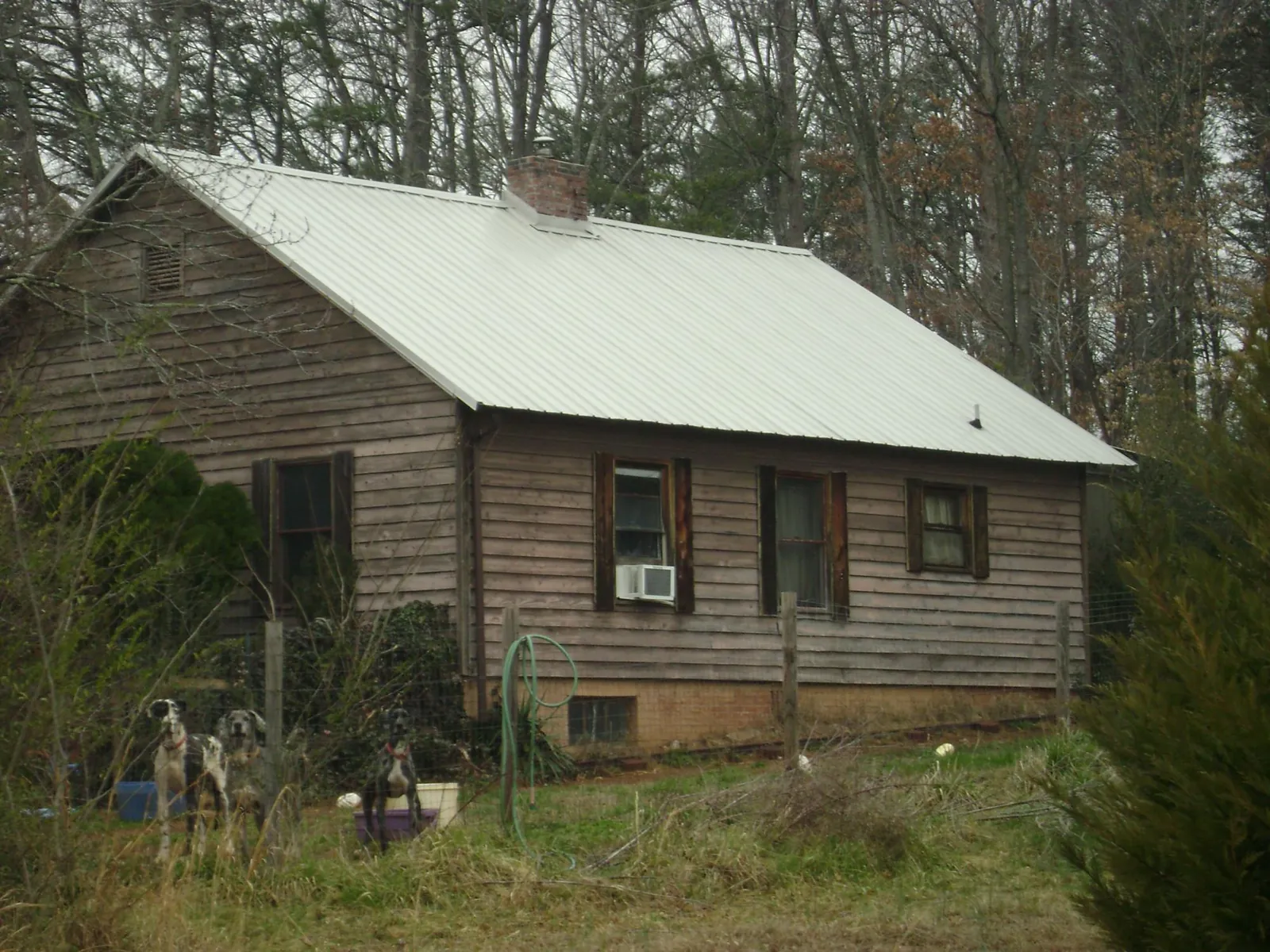White metal roof on an old wood sided farmhouse, from a Metal Roof Installation job in Somerville
